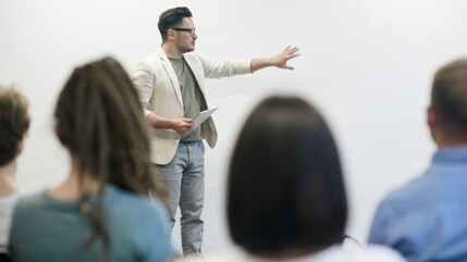 Photo of a person giving a talk to a group of people